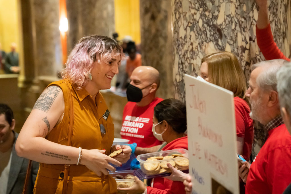 Rep. Leigh Finke grabbed a cookie from members of Moms Demand Action outside the Minnesota Legislature Senate Chamber