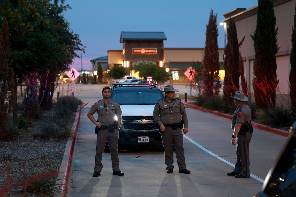 Texas Department of Public Safety officers block an entranceway to the Allen Premium Outlets mall May 7, 2023 in Allen, Texas. Officials continue to investigate the May 6th mass shooting at the Allen Premium Outlets mall.