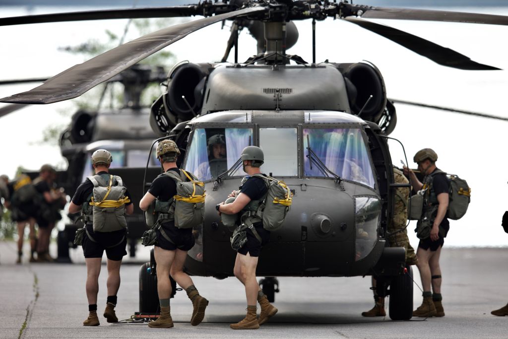soldiers in short compression shorts circling helicopter