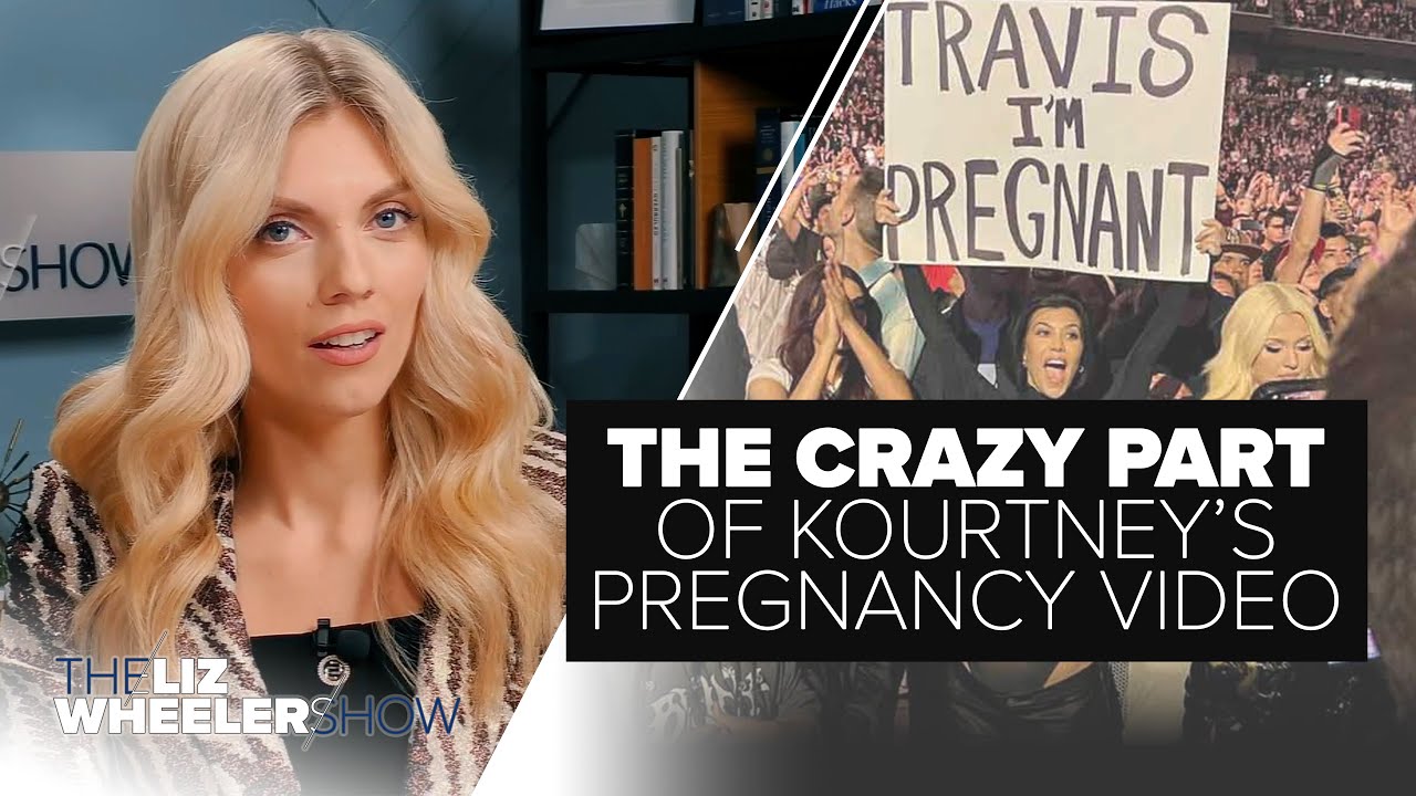 Kourtney Kardashian holds up a sign that says "Travis I'm Pregnant" at a Blink-182 concert