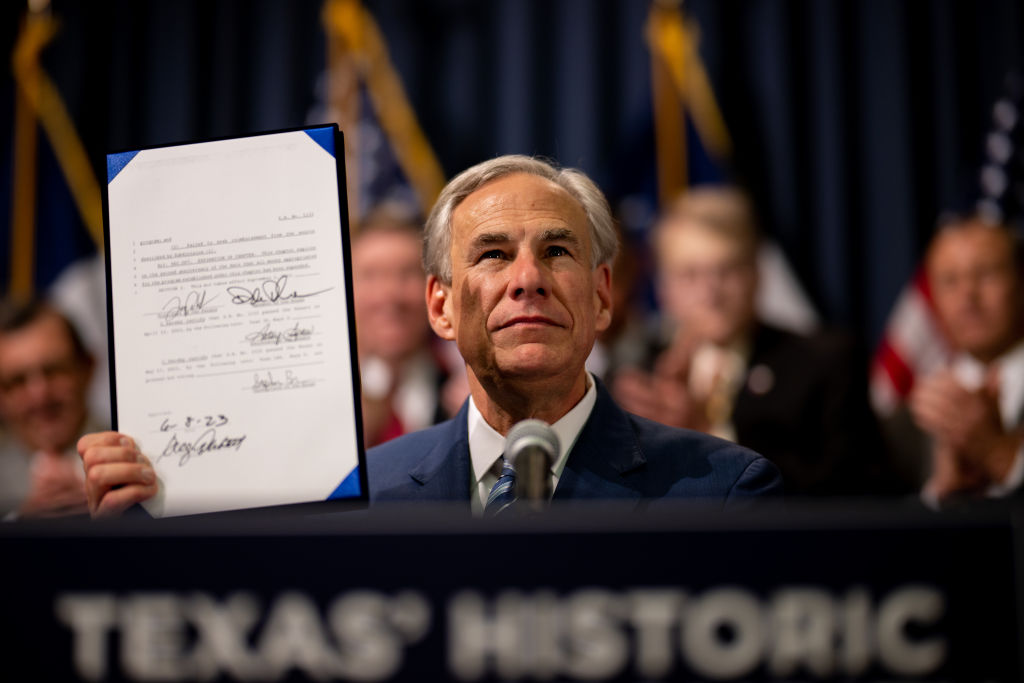 Texas Gov. Greg Abbott displays a signed bill during a news conference on June 08, 2023 in Austin, Texas.