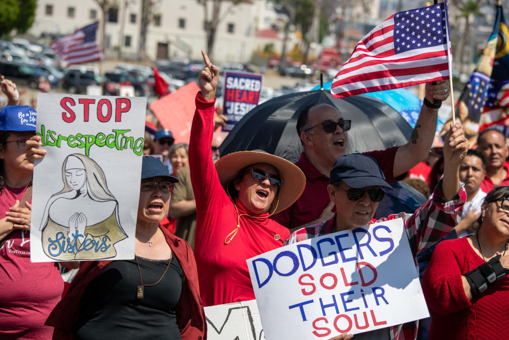 Christians hold signs as they gathered to pray and protest against the Dodgers inclusion of the Sisters of Indulgence in their Pride Night program at Dodger Stadium on Friday, June 16, 2023 in Los Angeles, CA.