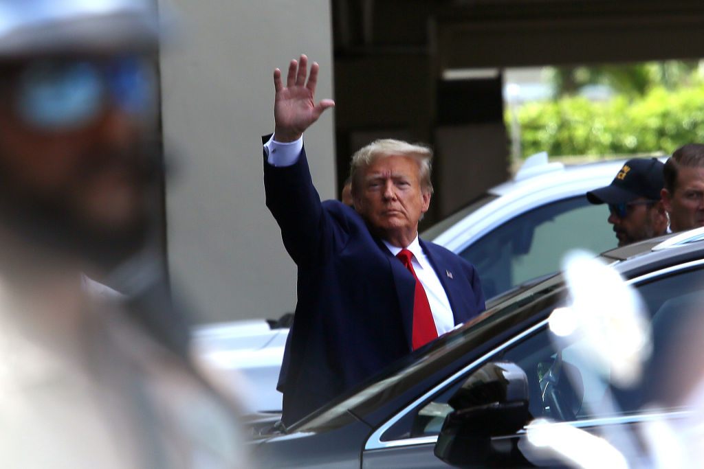 Former U.S. President Donald Trump waves as he makes a visit to the Cuban restaurant Versailles after he appeared for his arraignment on June 13, 2023 in Miami, Florida. Trump pleaded not guilty to 37 federal charges including possession of national security documents after leaving office, obstruction, and making false statements.