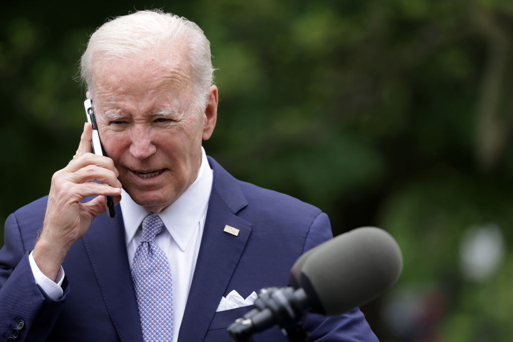 U.S. President Joe Biden talks on a cell phone during a Rose Garden event at the White House to mark National Small Business Week on May 1, 2023 in Washington, DC.
