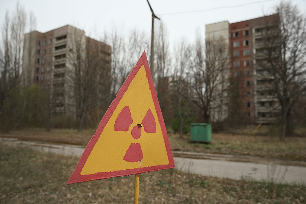 A sign warns of radiation contamination near former apartment buildings on April 9, 2016 in Pripyat, Ukraine. Pripyat, built in the 1970s as a model Soviet city to house the workers and families of the Chernobyl nuclear power plant, now stands abandoned inside the Chernobyl Exclusion Zone, a restricted zone contaminated by radiation from the 1986 meltdown of reactor number four at the nearby Chernobyl plant in the world's worst civilian nuclear accident that spewed radiaoactive fallout across the globe.