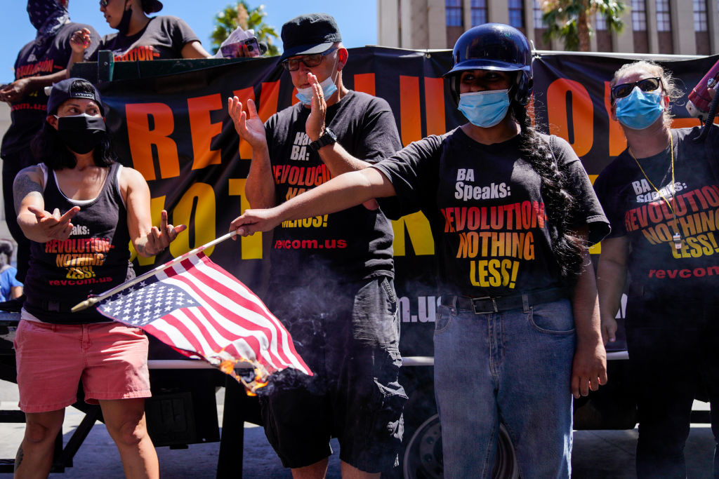 Protesters set fire to an American flag near President Donald Trumps Star on the Hollywood Walk of Fame, part of the Demonstrate How to Dishonor the American Flag event put on by the Revolution Club in Los Angeles on Saturday, July 4, 2020 in Los Angeles, CA. The event was led by Activist Gregory `Joey' Johnson will burn the U.S. flag to protest President Donald Trump's call to re-criminalize flag burning.