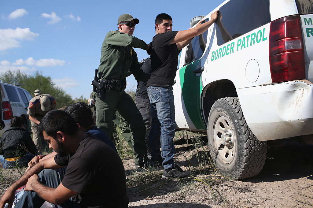A U.S. Border Patrol officer body searches an undocumented immigrant after he illegally crossed the U.S.-Mexico border and was caught on December 7, 2015 near Rio Grande City, Texas.