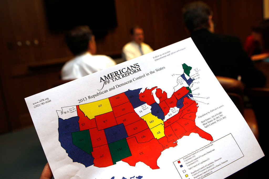 Conservative libertarian Grover Norquist shows a map of 2013 republican and democrat control of states' executive branch and legislature during an interview from the San Francisco Chronicle editorial board in San Francisco, California, on Friday, April 5, 2013.