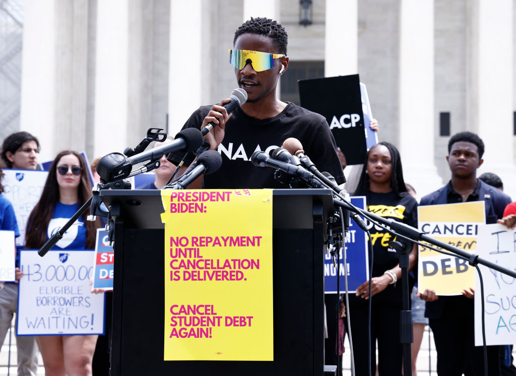 Derrick Lewis, NAACP Y&C, joins student loan borrowers to demand President Biden use "Plan B" to cancel student debt Immediately at a rally outside of the Supreme Court of the United States on June 30, 2023 in Washington, DC.