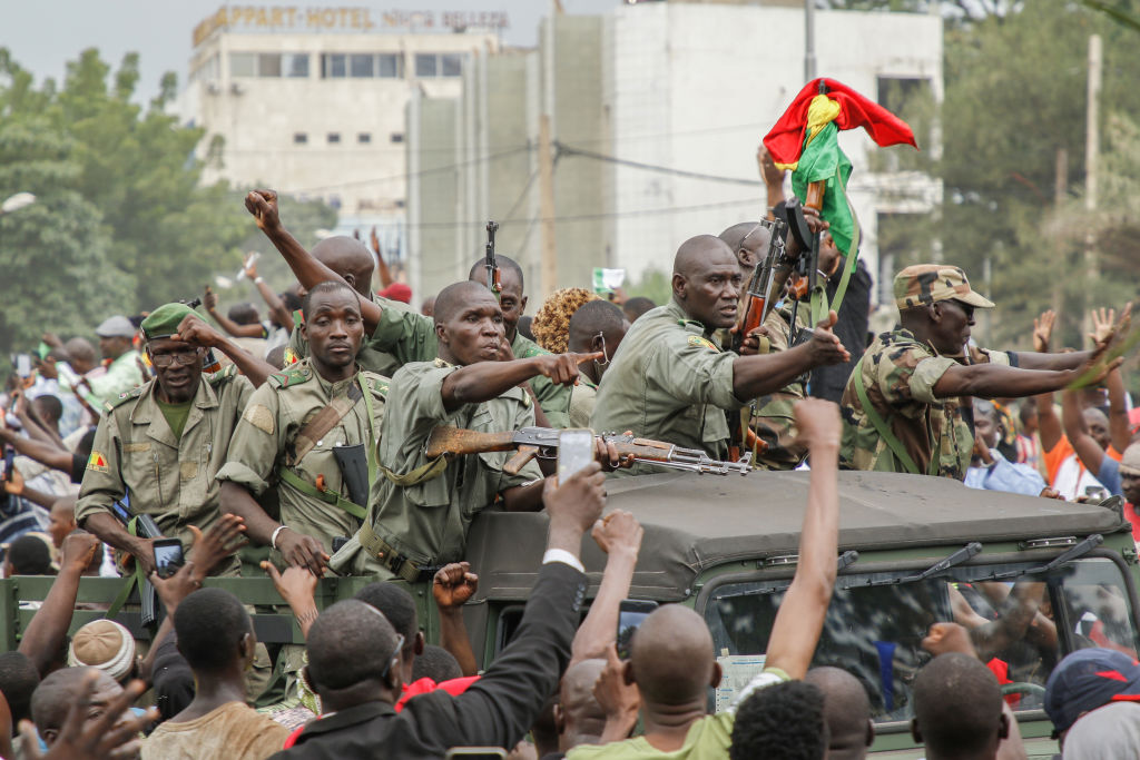 Crowds cheer as soldiers parade in vehicles along the Boulevard de l'Independance on August 18, 2020 in Bamako, Mali. President Ibrahim Boubacar Keita and Prime Minister Boubou Cisse have been taken captive by mutinying soldiers, according to multiple news reports.