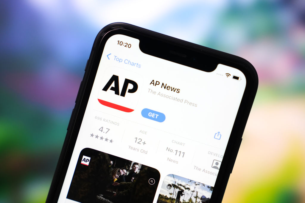 In this photo illustration, the Associated Press App logo seen displayed on the screen of a smartphone.