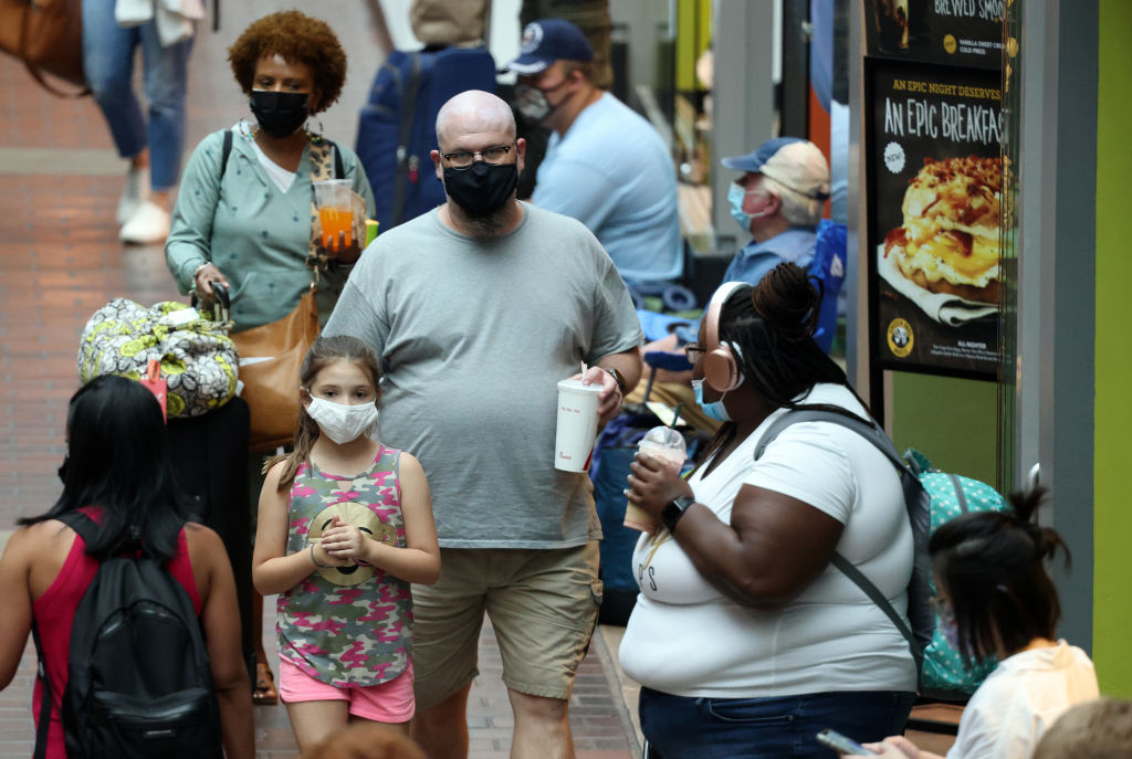 People wear masks as they walk through Union Station on July 30, 2021 in Washington, DC.