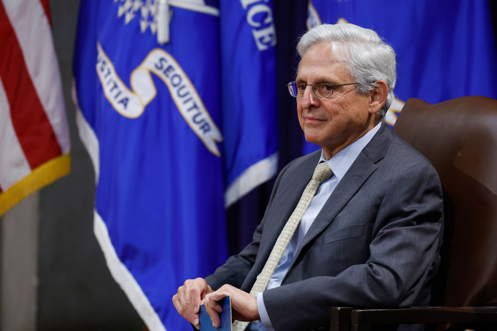 Attorney General Merrick Garland listens as Rosemarie Hidalgo, the director of the office on Violence Against Women, gives remarks after her formal investiture ceremony in the Great Hall of the Department of Justice on August 15, 2023 in Washington, DC.