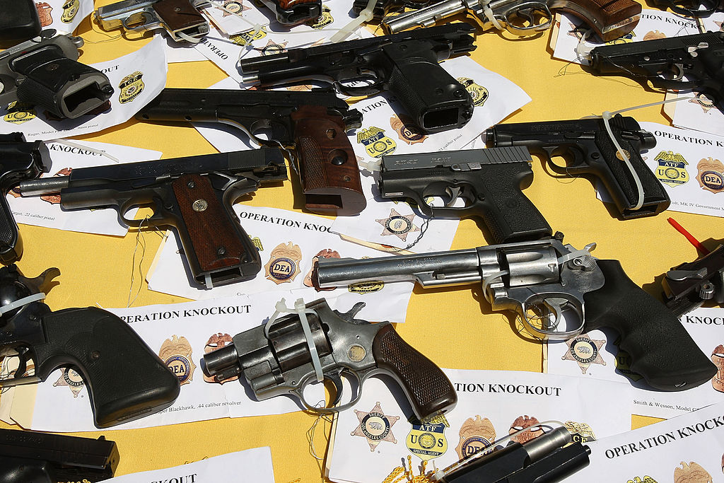 Some of about 125 weapons confiscated during what the federal authorities say is the largest gang takedown in United States history are displayed at a press conference to announce the arrests of scores of alleged gang members and associates on federal racketeering and drug-trafficking charges on May 21, 2009 in the Los Angeles-area community of Lakewood, California.