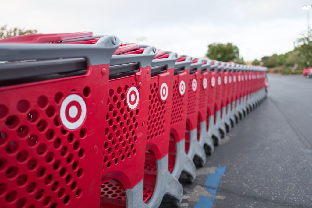Selective-focus image of a long row of red Target shopping cars in the parking lot of a Target department store in Dublin, California, May 21, 2018.