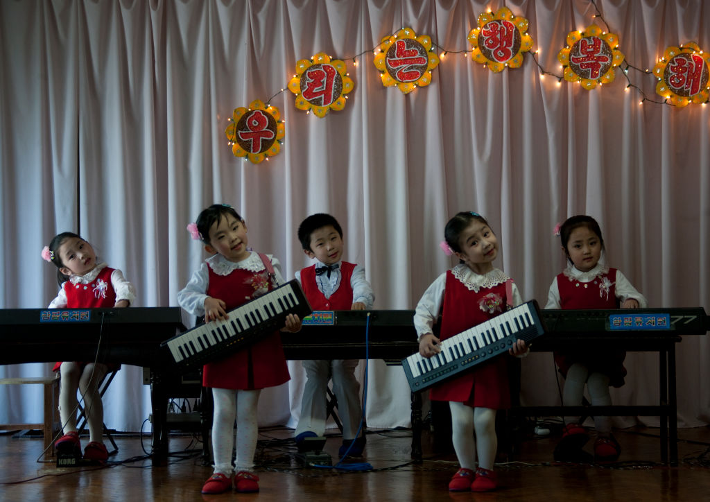 North Korean children playing music in Kwangbok school, Pyongan Province, Pyongyang, North Korea on April 29, 2010