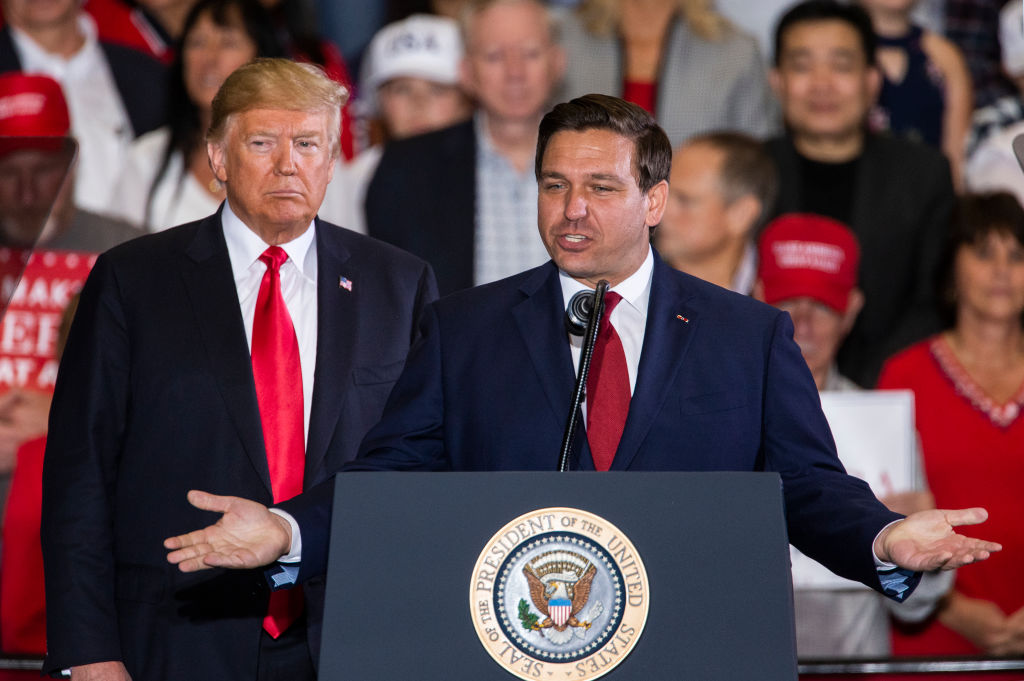 Florida Republican gubernatorial candidate Ron DeSantis speaks with U.S. President Donald Trump at a campaign rally at the Pensacola International Airport on November 3, 2018 in Pensacola, Florida.