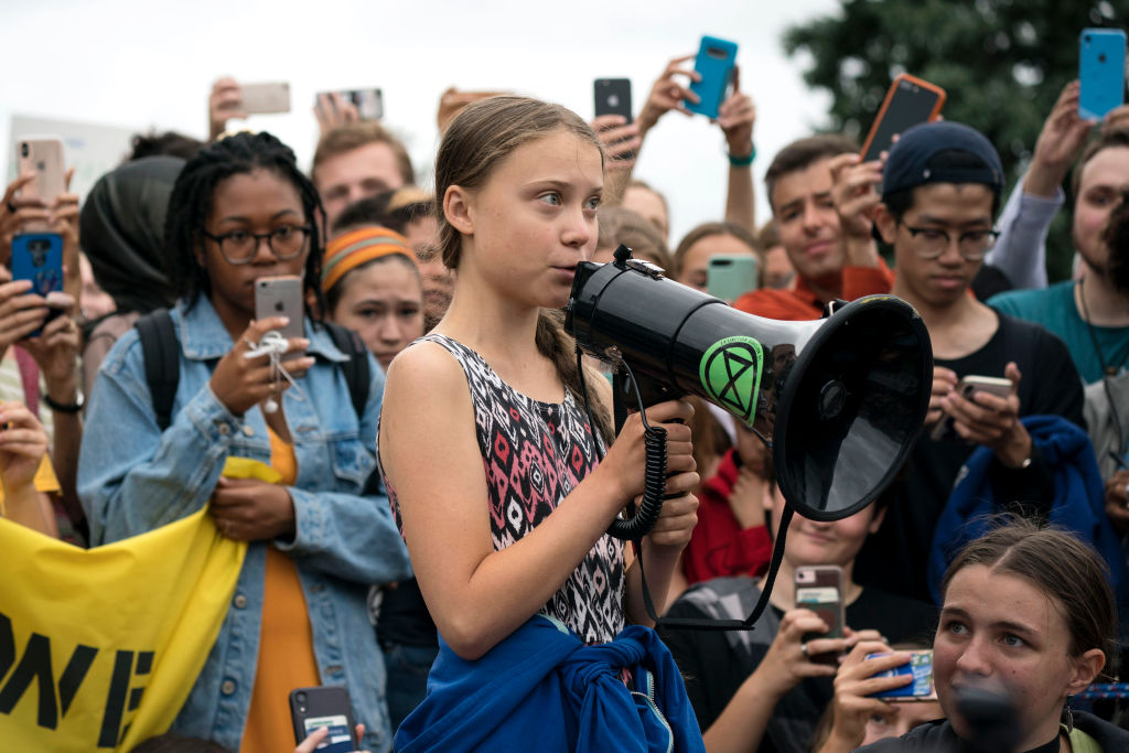 Teenage Swedish climate activist Greta Thunberg delivers brief remarks surrounded by other student environmental advocates during a strike to demand action be taken on climate change outside the White House on September 13, 2019 in Washington, DC.