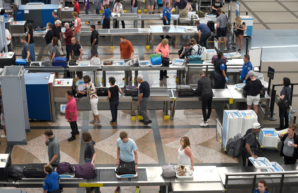 Airport passengers proceed through the TSA security checkpoint at Denver International Airport in Denver, Colorado.