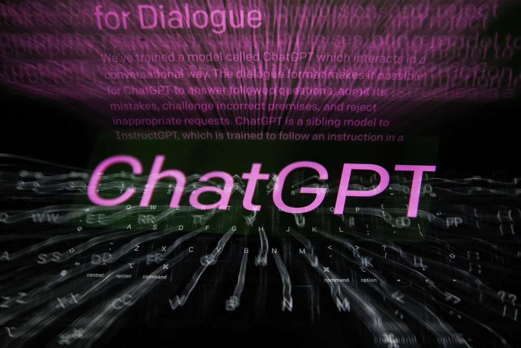 ChatGPT sign displayed on a phone screen and OpenAI ChatGPT website displayed on a laptop screen are seen in this multiple exposure illustration photo taken in Krakow, Poland on February 26, 2023.