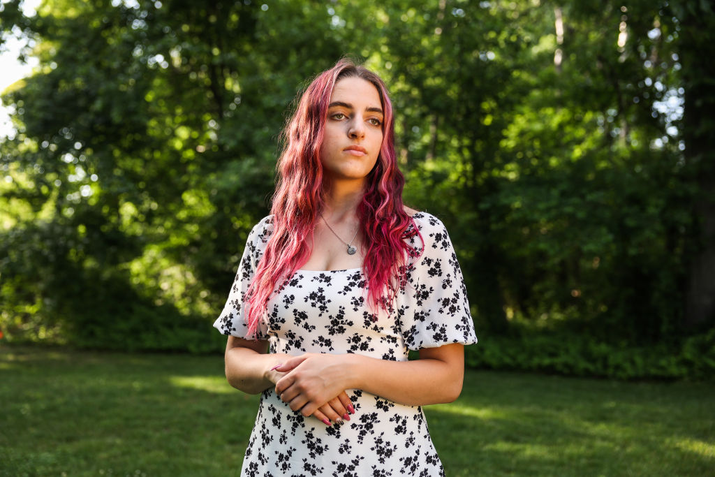 Alexis Spence, 19, stands outside her home in Yaphank, New York on June 8, 2022. Spence and her family filed a personal injury suit filed against Meta, the parent company of Instagram. The suit alleges that Instagram bombarded her with so much inappropriate content at an early age, that she became addicted to the social media app, which resulted in anxiety, depression, self-harm starting when she was 11 years old.