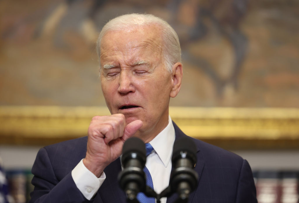 U.S. President Joe Biden coughs as he delivers remarks on the contract negotiations between the United Auto Workers and auto companies in the Roosevelt Room at the White House on September 15, 2023 in Washington, DC.